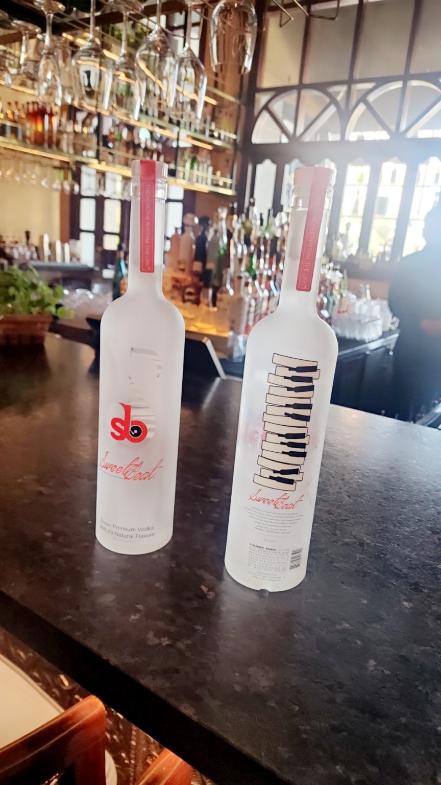 Two SweetBeat Vodka bottles displayed on a bar