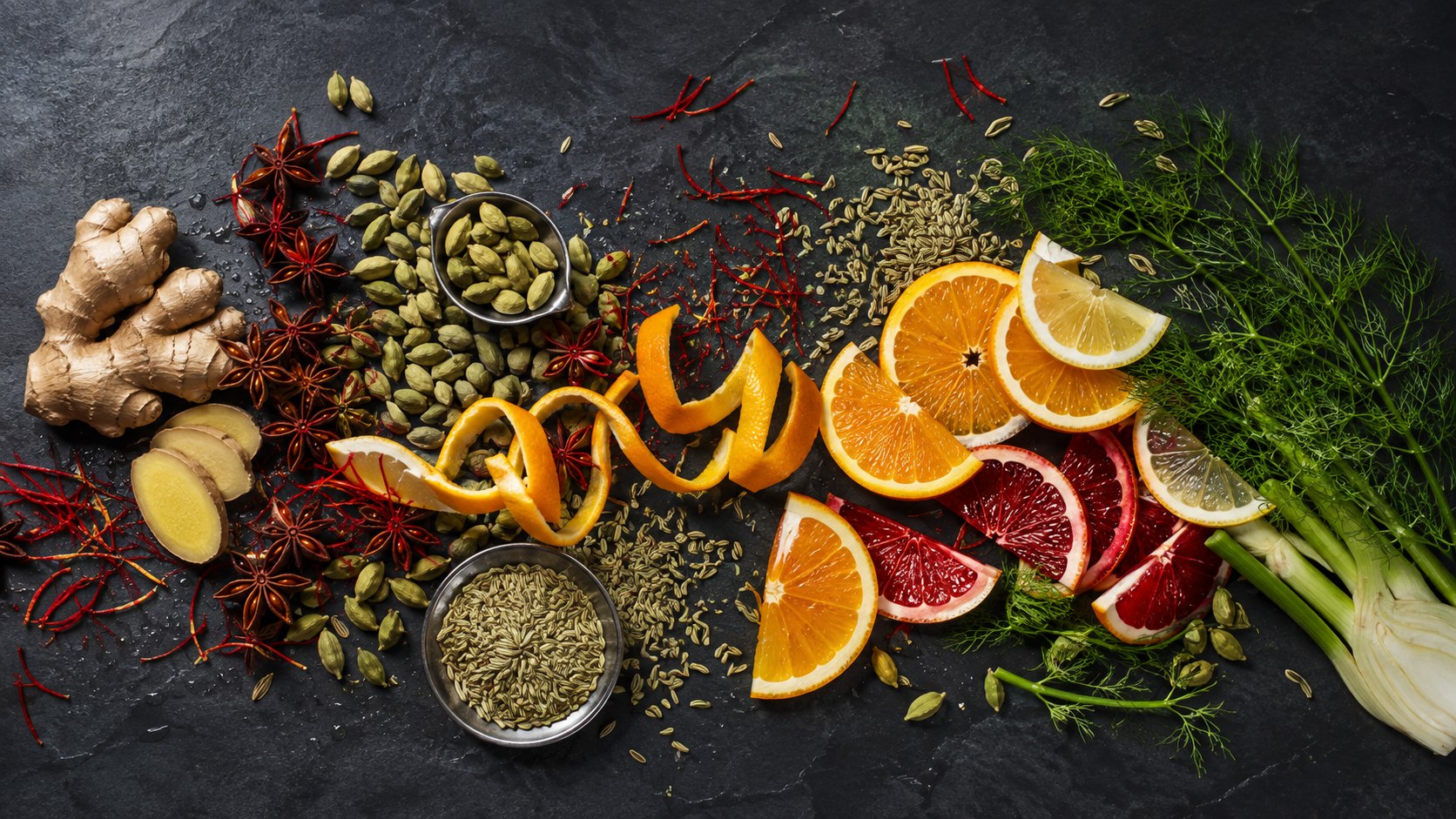 Citrus, ginger, cardamom, star anise and fennel arranged as a vibrant botanical spread