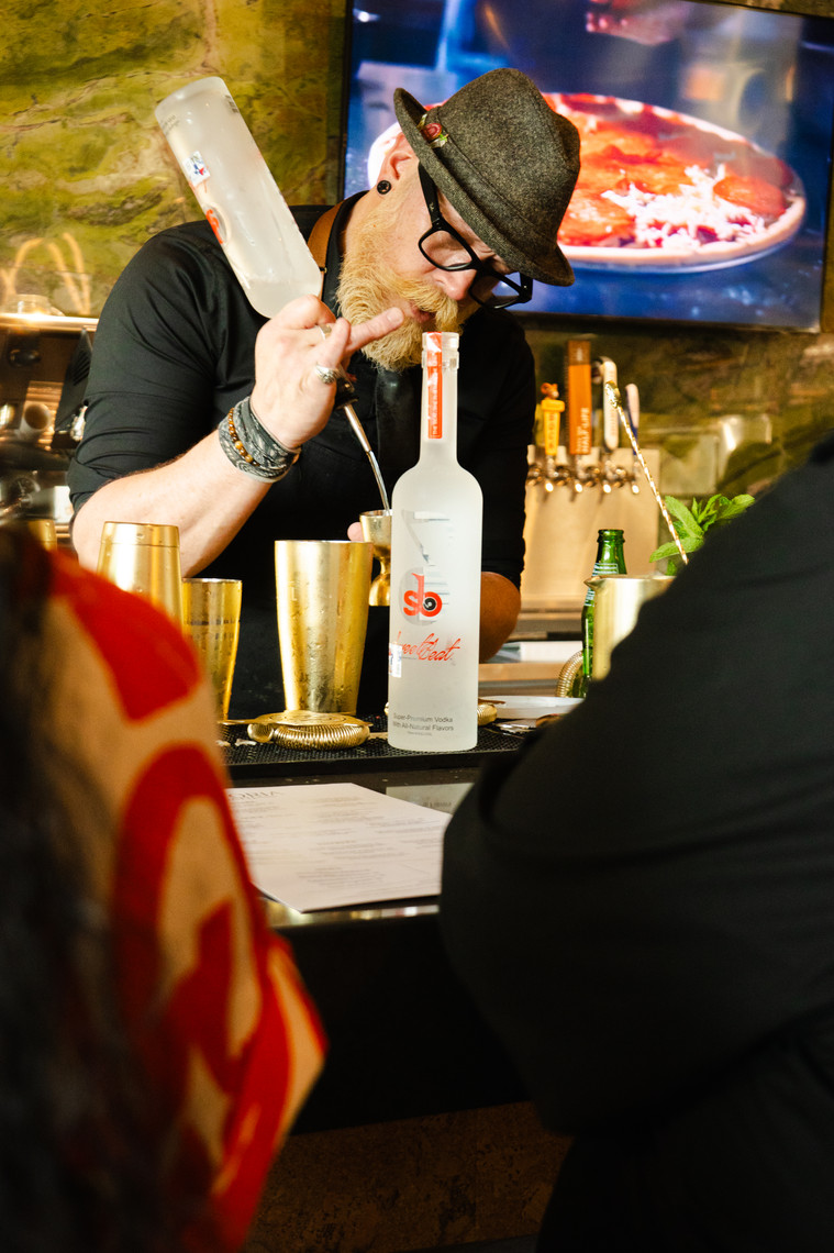 Bartender crafting a SweetBeat cocktail during service